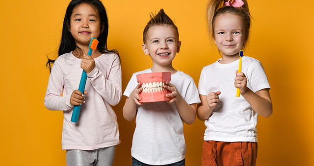 dental hygiene. happy little cute children with toothbrushes.