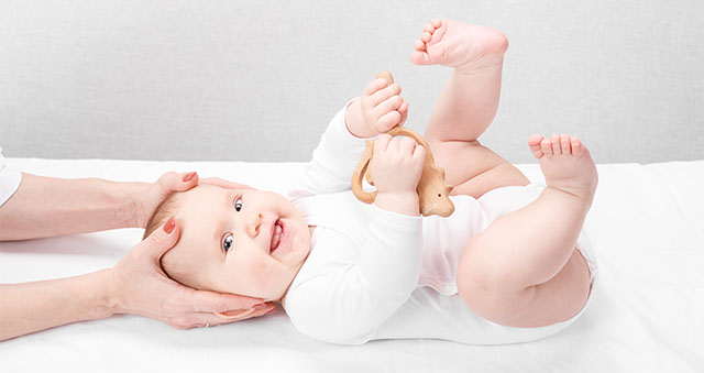 Little baby receiving osteopathic treatment of head and neck